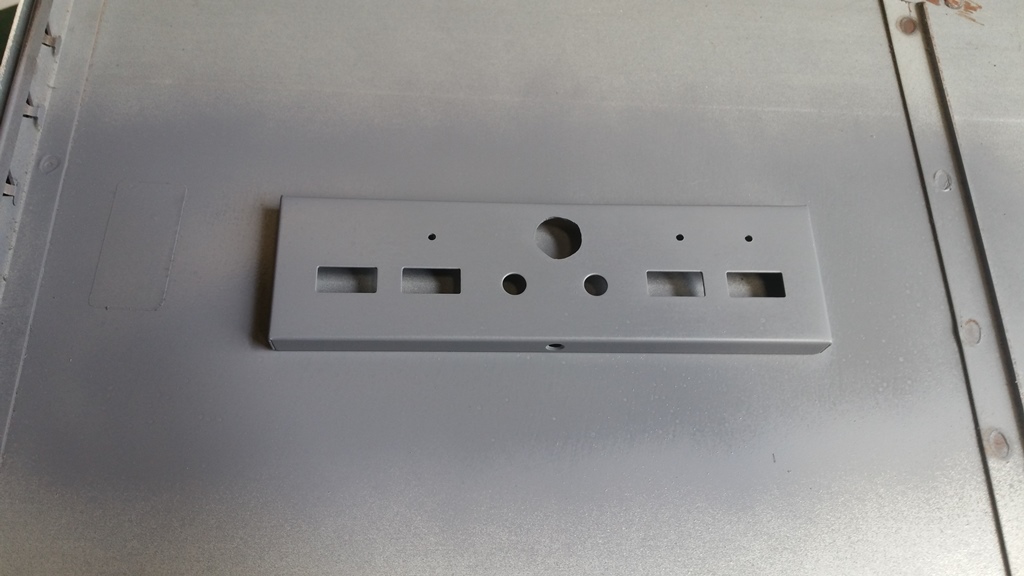 Front panel drilled and primed.